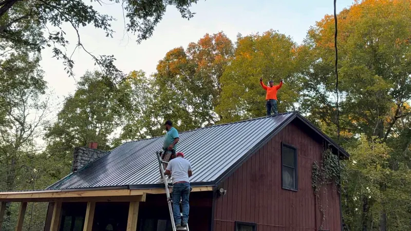 Crew member on a ladder setting metal panels